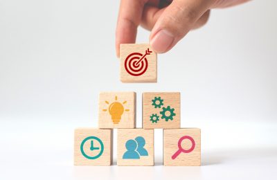 Concept of business strategy and action plan. Hand putting wooden cube block stacking with icon on white background.